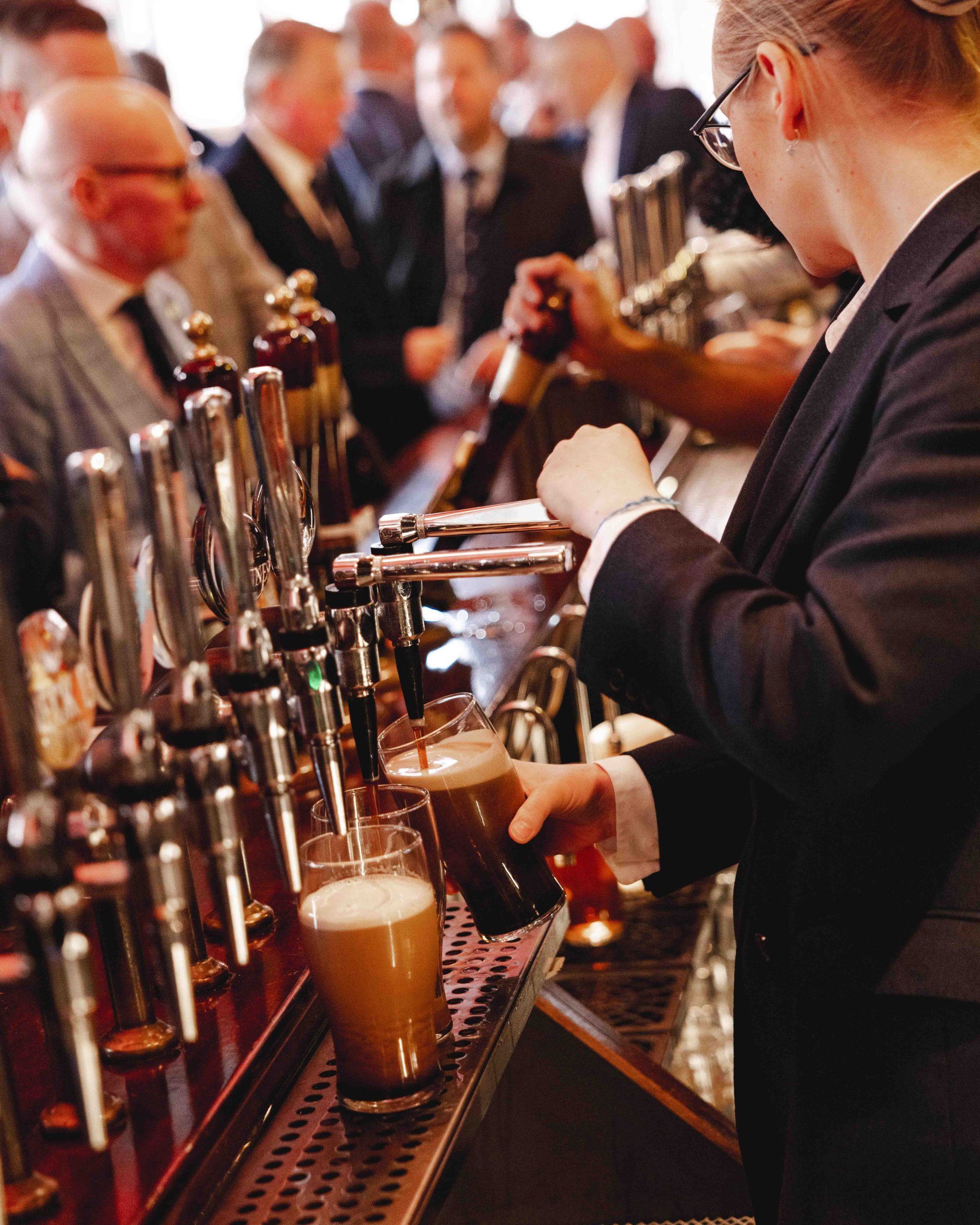 Waitress pouring pints at The Audley Public House in Mayfair